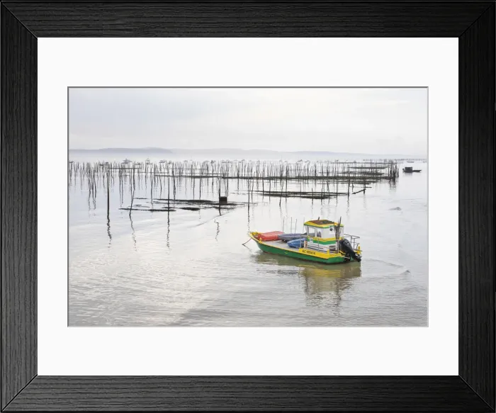 Framed Print : France, Nouvelle-Aquitaine, Gironde, Arcachon Bay, a fishing boat is moored by oyster Framed Print : France, Nouvelle-Aquitaine, Gironde, Arcachon Bay, a fishing boat is moored by oyster