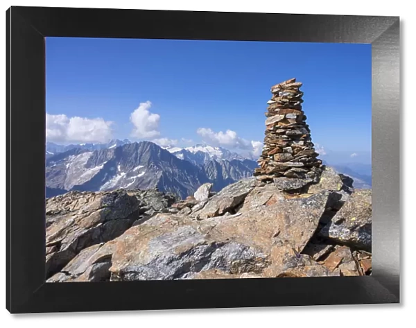 Summit cairn on Ofenhoren mountain with view at Bernese Alps, Urner Alps, canton Berne