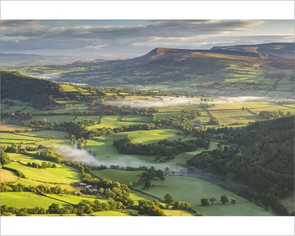 Wisps of mist float over the Usk Valley on an autumnal morning, Brecon Beacons, Powys