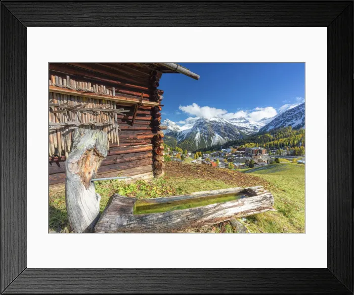 Framed Print : Traditional fountain with view on the alpine village. Arosa, Canton of Graubunden Framed Print : Traditional fountain with view on the alpine village. Arosa, Canton of Graubunden
