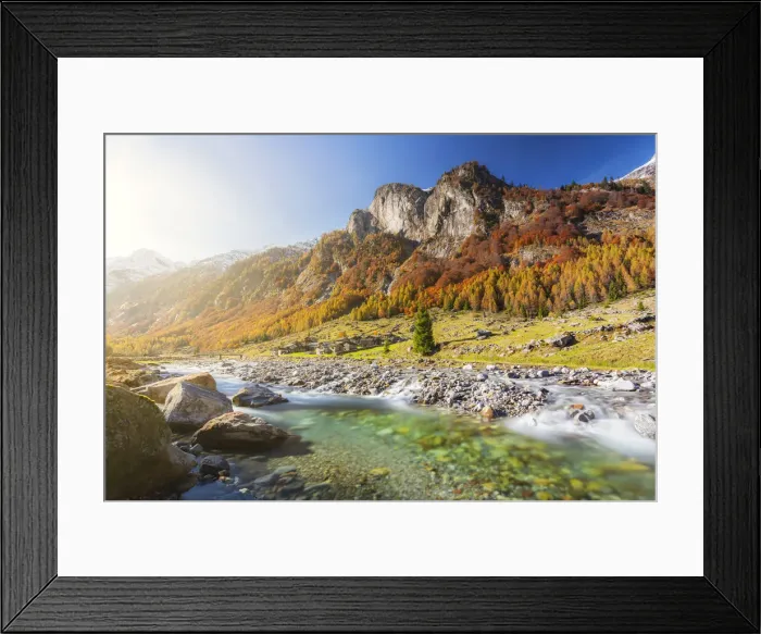 Framed Print : Alpine torrent with view on the alpine village in autumn Framed Print : Alpine torrent with view on the alpine village in autumn