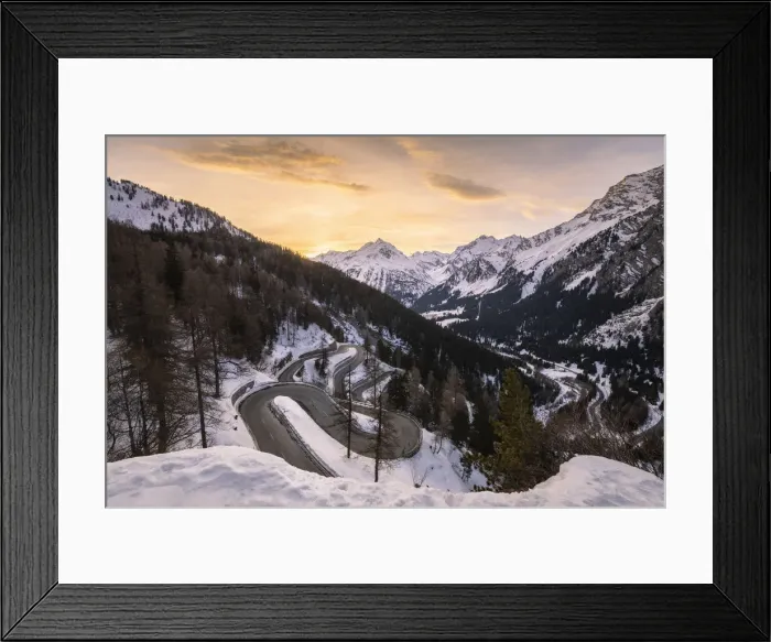 Framed Print : The winding curves of Maloja Pass road in winter at sunset, Bregaglia Valley, canton of Graubunden, Engadin, Switzerland Framed Print : The winding curves of Maloja Pass road in winter at sunset, Bregaglia Valley, canton of Graubunden, Engadin, Switzerland
