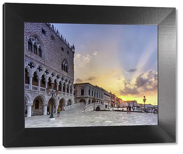 Doges Palace in Venice, Riva degli schiavoni, during the sunrise, with tourists