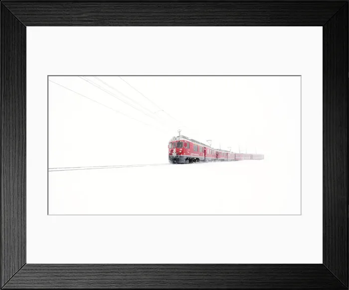 Framed Print : Bernina Express red train emerging from mist at Bernina Pass during a winter snowfall Framed Print : Bernina Express red train emerging from mist at Bernina Pass during a winter snowfall