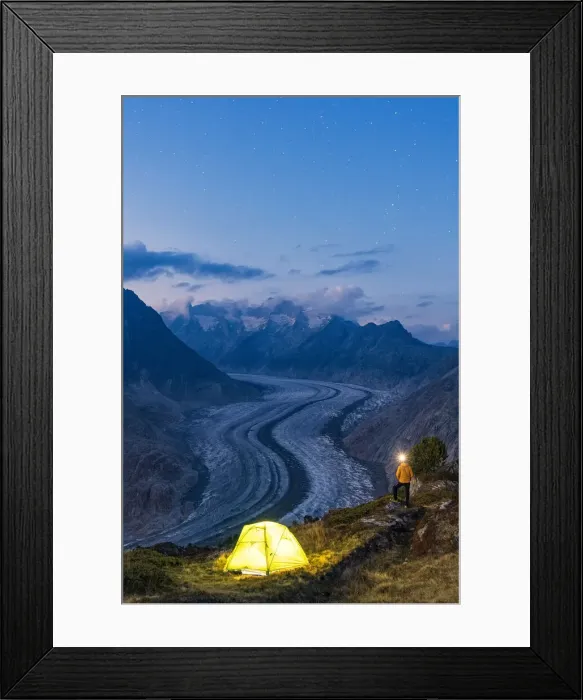 Framed Print : Hiker man with head torch light admiring Aletsch Glacier standing beside the tent Framed Print : Hiker man with head torch light admiring Aletsch Glacier standing beside the tent