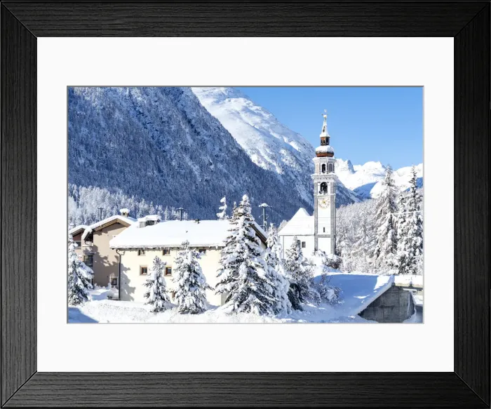Framed Print : Alpine village of Bever and old church after a snow blizzard in winter, Engadine Framed Print : Alpine village of Bever and old church after a snow blizzard in winter, Engadine