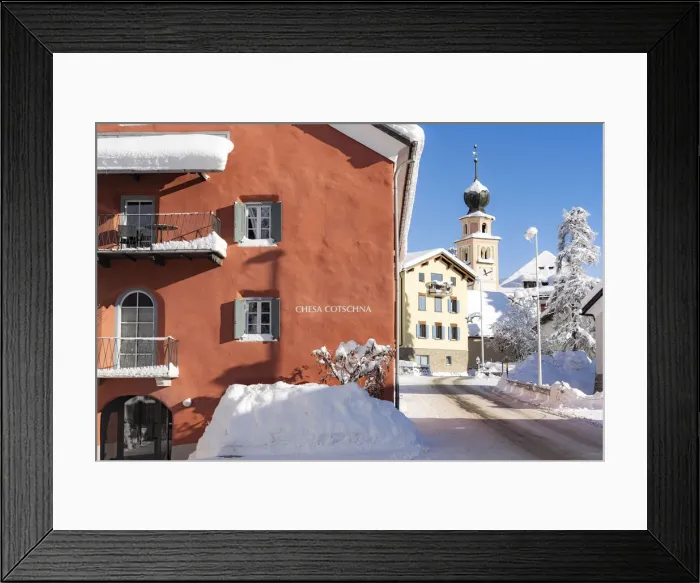 Framed Print : Traditional house and church in Madulain village covered with snow in winter Framed Print : Traditional house and church in Madulain village covered with snow in winter