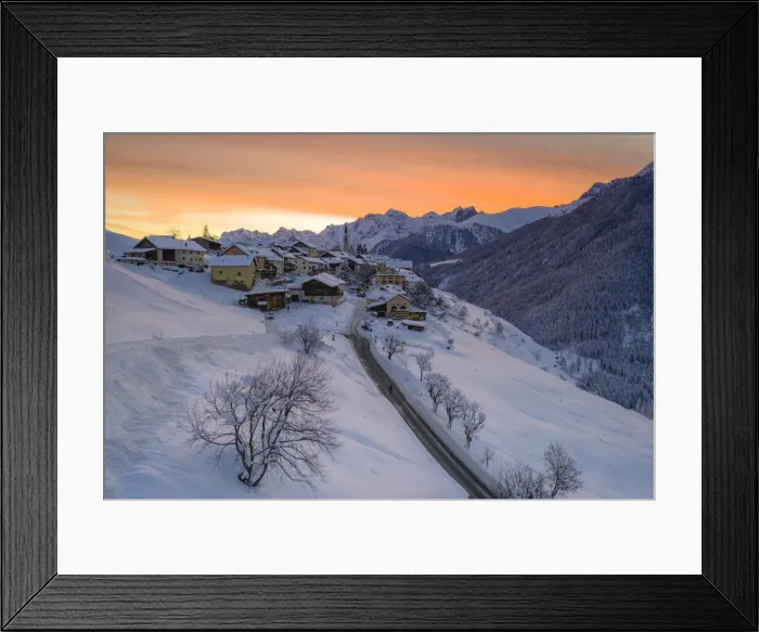 Framed Print : Sunrise over the empty road towards the village of Guarda after a winter snowfall Framed Print : Sunrise over the empty road towards the village of Guarda after a winter snowfall