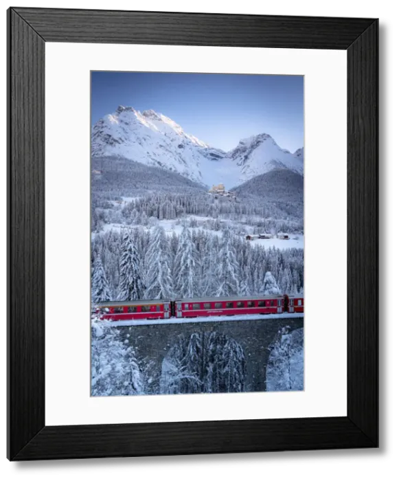 Framed Print : Bernina Express train on viaduct surrounding Tarasp Castle and snow capped mountains Framed Print : Bernina Express train on viaduct surrounding Tarasp Castle and snow capped mountains