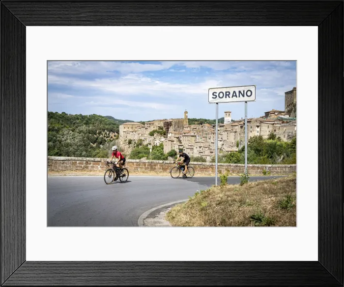 Framed Print : Two cyclist on the road towards the old town of Sorano, province of Grosseto, Tuscany Framed Print : Two cyclist on the road towards the old town of Sorano, province of Grosseto, Tuscany