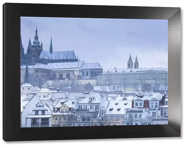 Scenic view of Prague Castle and snow-covered roofs in winter, Prague, Bohemia