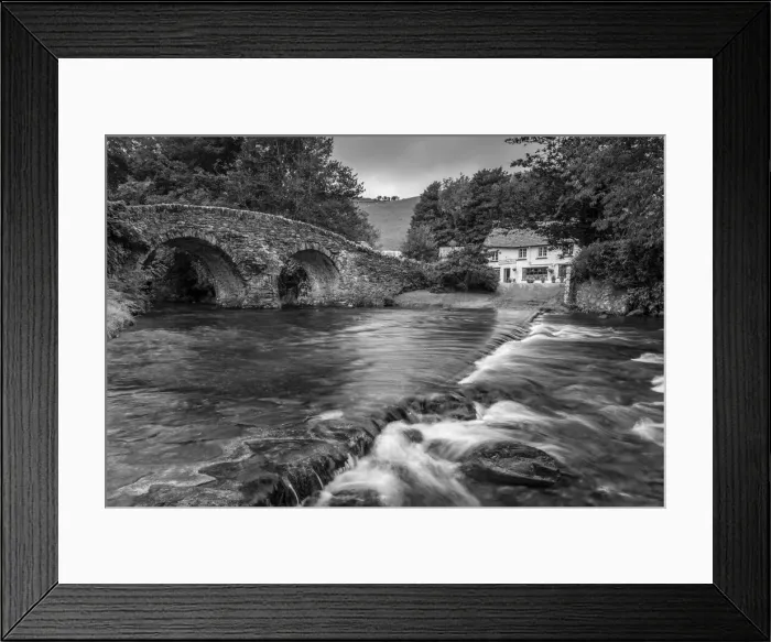 Framed Print : Stone bridge over Badgworthy Water in the picture postcard village of Malmsmead Framed Print : Stone bridge over Badgworthy Water in the picture postcard village of Malmsmead