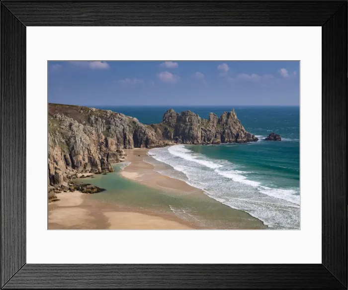Framed Print : Treryn Dinas and Logan Rock across the beautiful sandy beach at Pedn Vounder, Cornwall