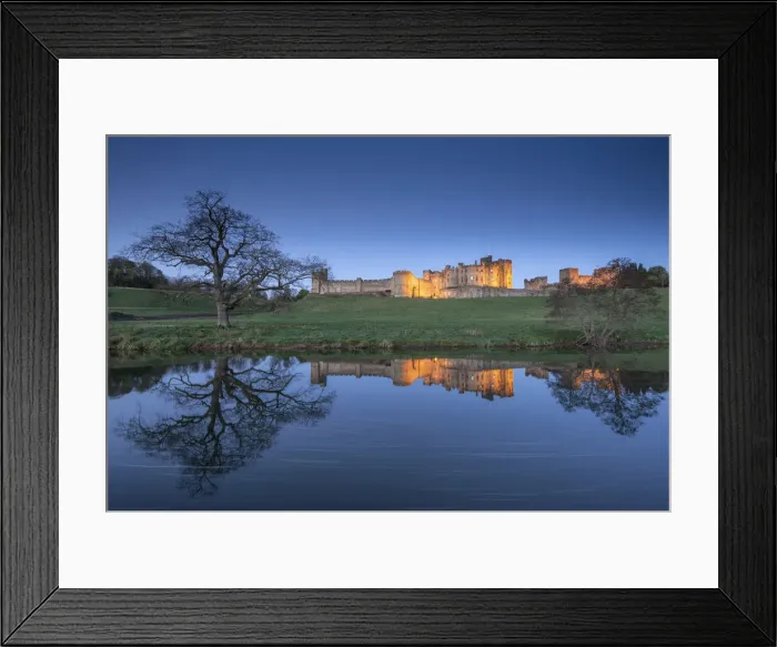 Framed Print : Alnwick Castle illuminated at twilight and reflected in the River Aln, Northumberland Framed Print : Alnwick Castle illuminated at twilight and reflected in the River Aln, Northumberland