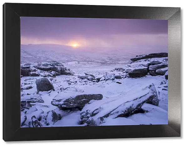 Sunrise over snow covered moorland at Great Staple Tor in Dartmoor National Park, Devon