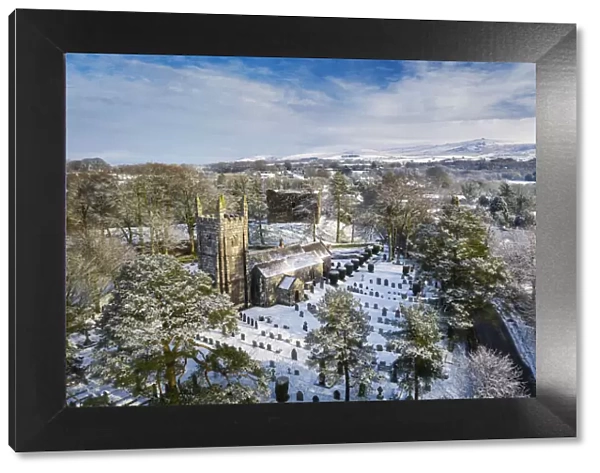 Aerial vista of St Petrocs Church and Lydford Castle on a snowy winter morning in