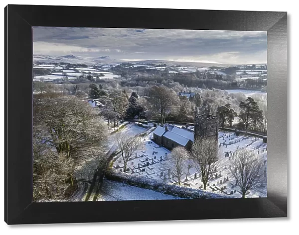Aerial vista of St Petrocs Church on a snowy winter morning in the Dartmoor village of
