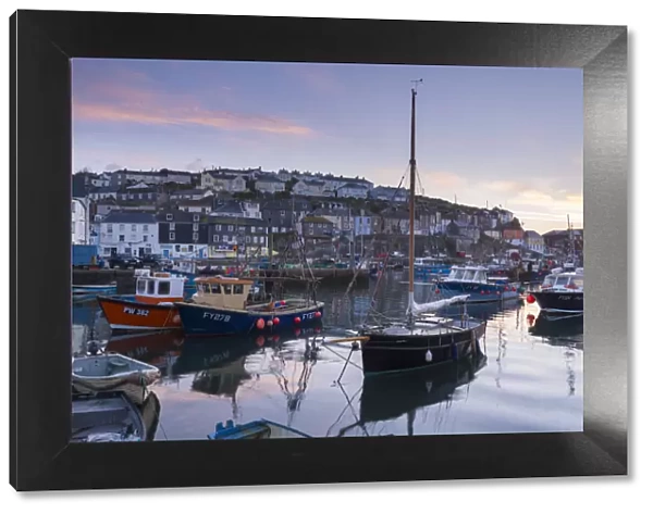 Pink dawn sky above Mevagissey harbour, Cornwall, England. Spring (May) 2015