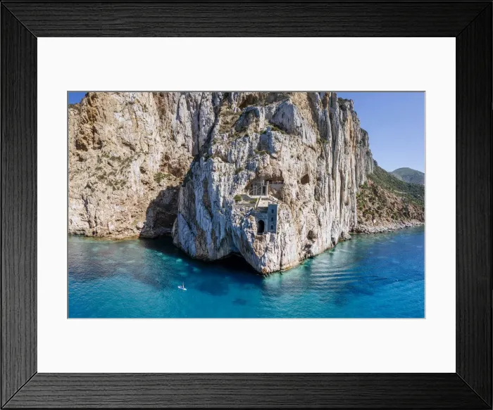 Framed Print : Old mining area in the rock above the turquoise sea in Sardinia, Italy. Porto Flavia