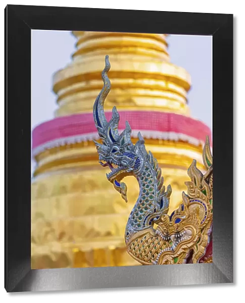 Thailand, Lampang, Wat Pong Sanuk Nua, dragon decoration and golden chedi