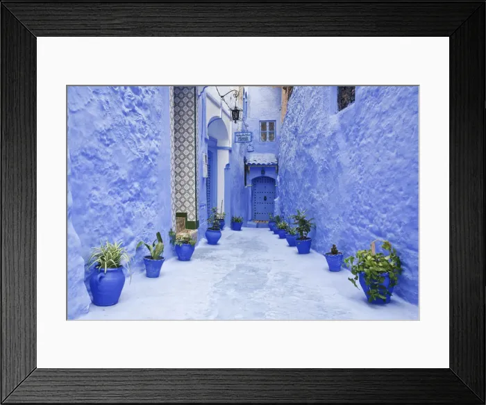 Framed Print : Blue painted alley lined with flower pots leading to doorway, Chefchaouen, Morocco