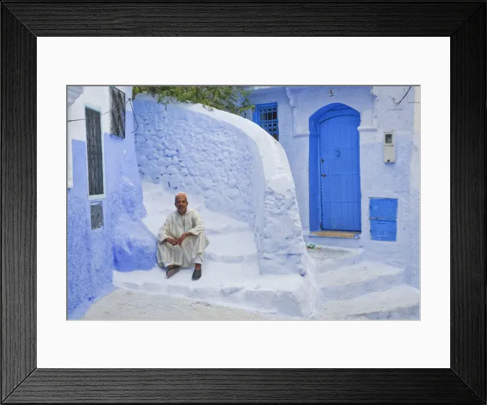 Framed Print : Man in traditional Moroccan clothing sitting on blue painted steps, Chefchaouen Framed Print : Man in traditional Moroccan clothing sitting on blue painted steps, Chefchaouen