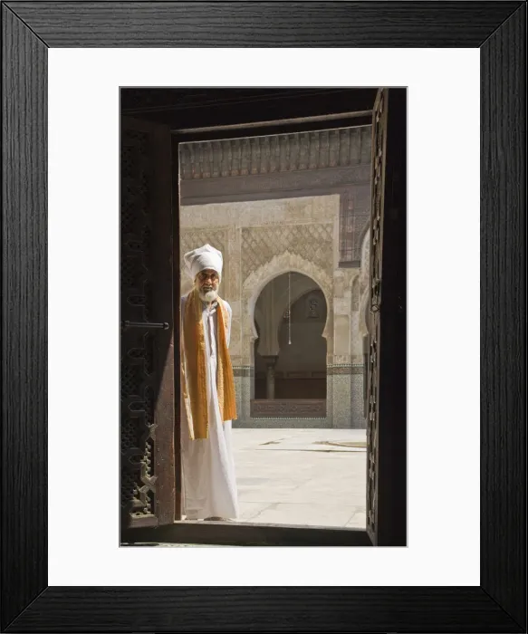Framed Print : Man in traditional Moroccan clothing standing in doorway of Bou Inania Medersa, Fez Framed Print : Man in traditional Moroccan clothing standing in doorway of Bou Inania Medersa, Fez