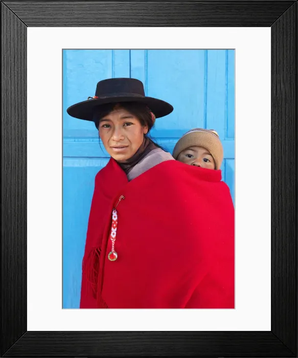 Framed Print : Portrait of an Aymara mother in traditional clothes with her child standing in front of