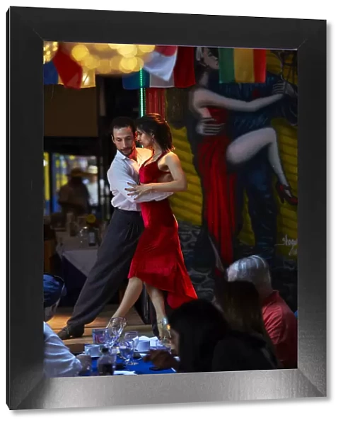 A couple of tango dancers perform a live-show in a restaurant of La Boca, Buenos Aires