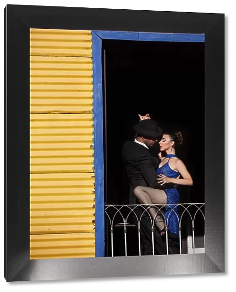 A couple of Professional Tango dancers inside a colorful house of La Boca, Buenos Aires, Argentina. (MR)