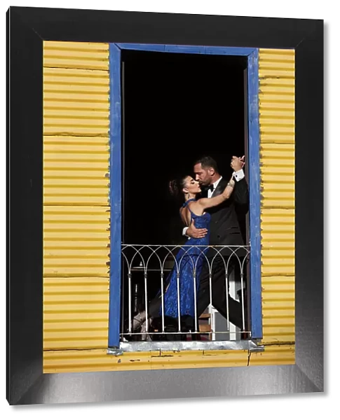 A couple of Professional Tango dancers inside a colorful house of La Boca, Buenos Aires, Argentina. (MR)