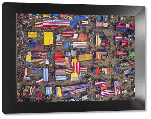 Aerial view of people in a traditional local fish market with colourful bazaars in