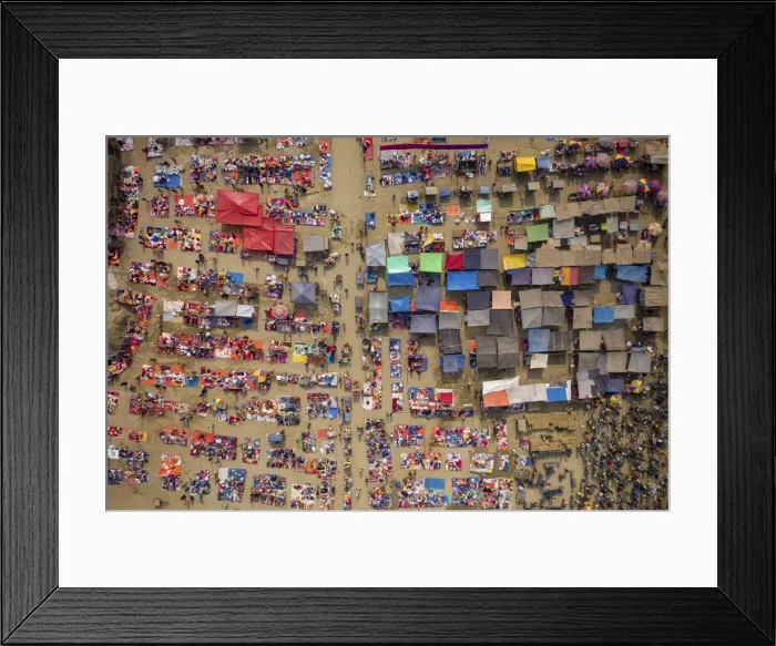 Framed Print : Aerial view of people trading at weekly market, seeking out products in the city of Framed Print : Aerial view of people trading at weekly market, seeking out products in the city of