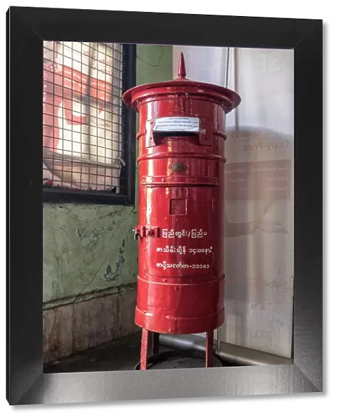 Old colonial style red letterbox in post office in Yangon, Myanmar