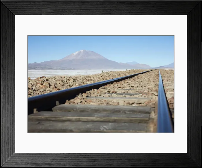 Framed Print : A train track on the Bolivian plateau with the OllagAoe volcano in the background Framed Print : A train track on the Bolivian plateau with the OllagAoe volcano in the background