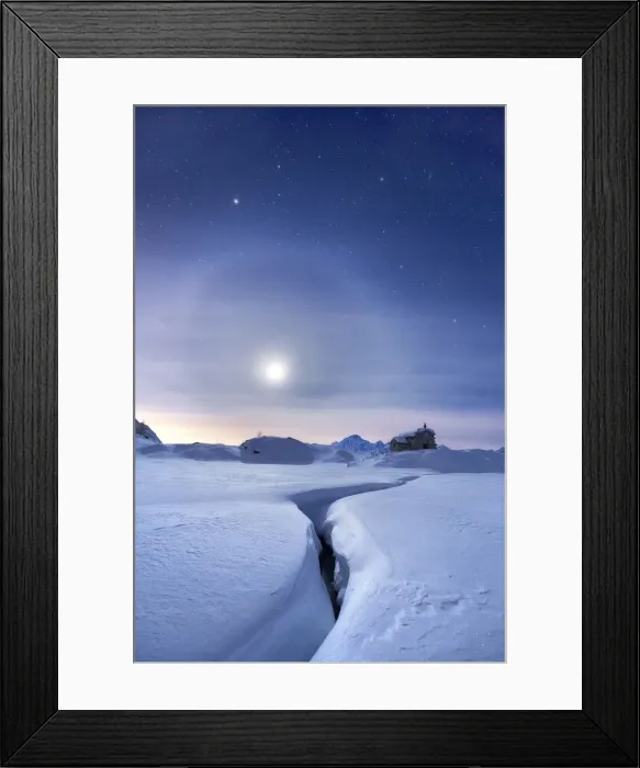 Framed Print : Moon halo in the night sky above a traditional mountain church during a winter full moon Framed Print : Moon halo in the night sky above a traditional mountain church during a winter full moon