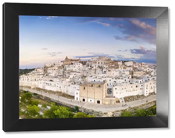 Traditional white buildings of Ostuni at sunset, aerial view, province of Brindisi