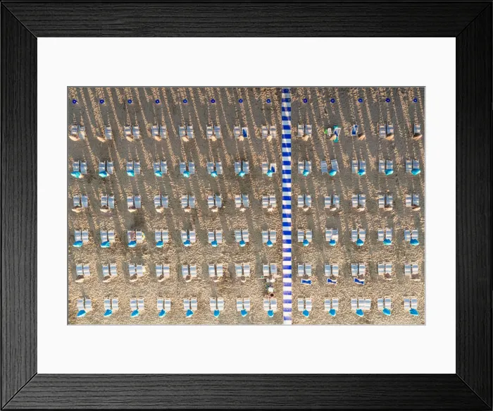 Framed Print : Aerial view of white sunbeds in a row on empty sand beach in summer, Vieste Framed Print : Aerial view of white sunbeds in a row on empty sand beach in summer, Vieste