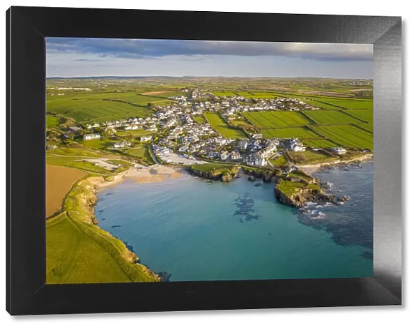 Aerial view of Trevone Beach and village in evening sunlight, Trevone, Cornwall, England