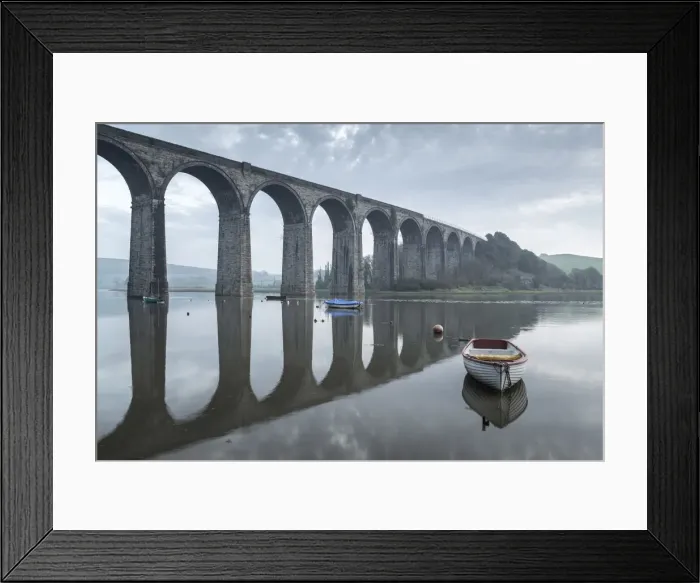 Framed Print : Boats moored beneath the towering arches of St Germans viaduct at dawn