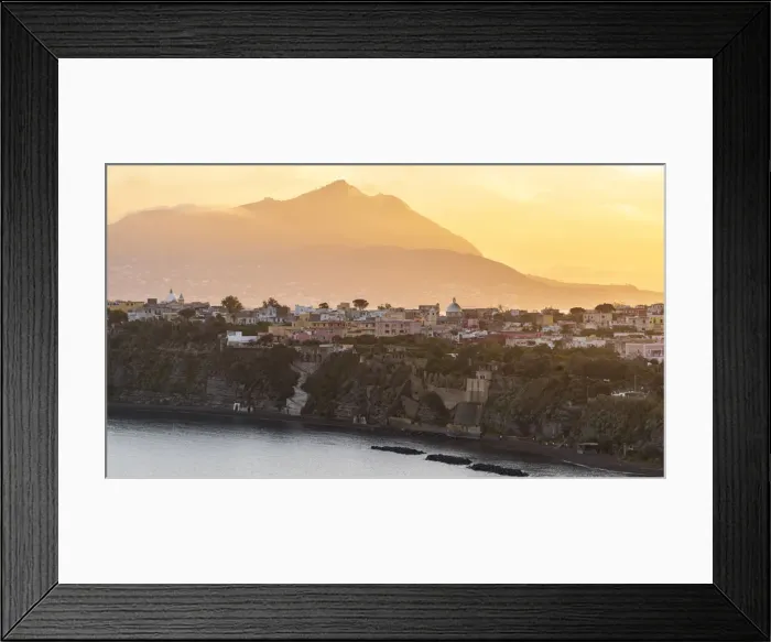 Framed Print : Europe, Italy, Campania. Procida island at sunset with the impressive Vesuvius in