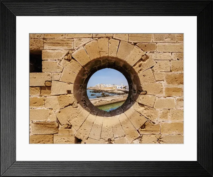 Framed Print : Round window in the walls of the Citadel by the Scala Harbour, Essaouira