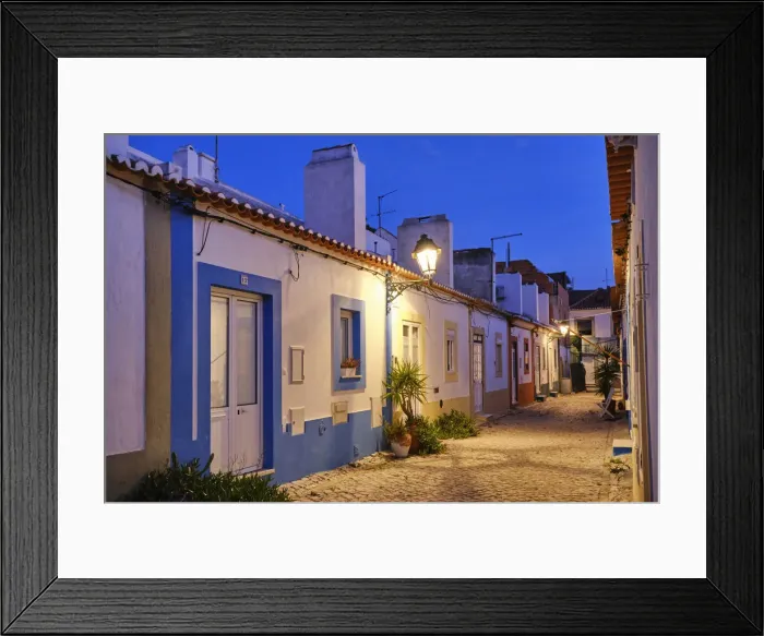 Framed Print : Street of the traditional fishing village of Alcochete, spreading along the river Tagus