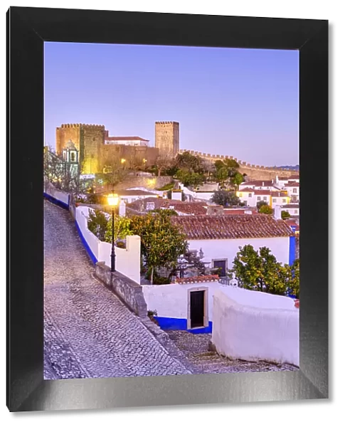 Obidos and the castle at dusk. A traditional medieval village taken to the moors in