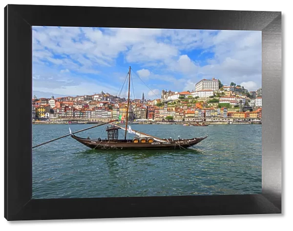 Rabelo boats in Porto with river Douro and bishops palace, Ribeira, Portugal