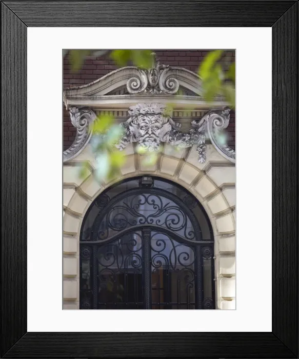 Framed Print : Detail of a mascaron ornament on the main facade of a building in Art Nouveau style
