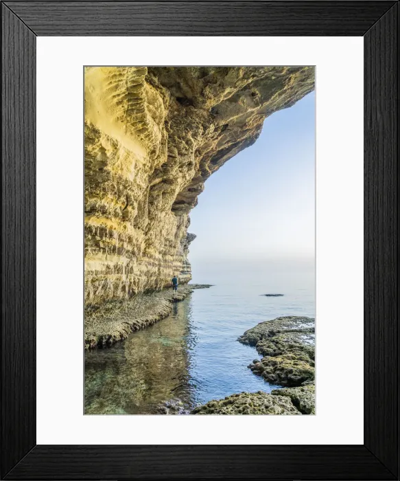 Framed Print : A man walking at the sea caves at Cape Greco, Famagusta District, Cyprus Framed Print : A man walking at the sea caves at Cape Greco, Famagusta District, Cyprus