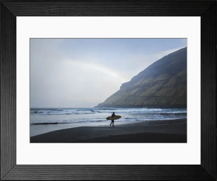 Framed Print : A surfer walking along the beach in Tjornuvik. Streymoy, Faroe Islands Framed Print : A surfer walking along the beach in Tjornuvik. Streymoy, Faroe Islands