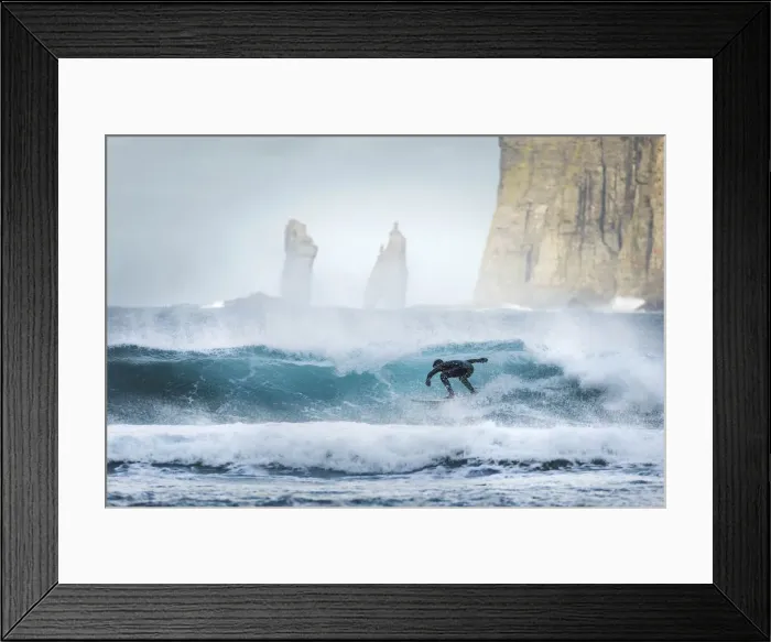 Framed Print : A guy surfing along the coast in front of Tjornuvik. In the background the Risin og Kellingin sea stacks. Streymoy, Faroe Islands Framed Print : A guy surfing along the coast in front of Tjornuvik. In the background the Risin og Kellingin sea stacks. Streymoy, Faroe Islands