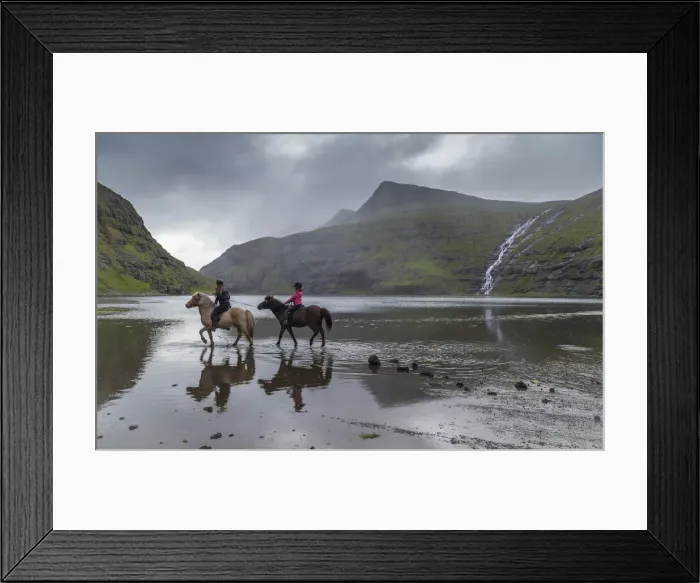 Framed Print : Girls riding horses in the lagoon in Saksun. Streymoy, Faroe Islands